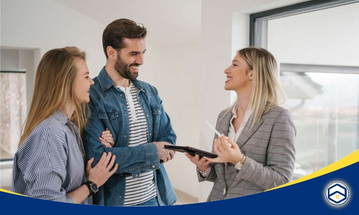 A real estate agent discusses with a couple in a bright, modern interior, showing them an apartment maintenance requests 