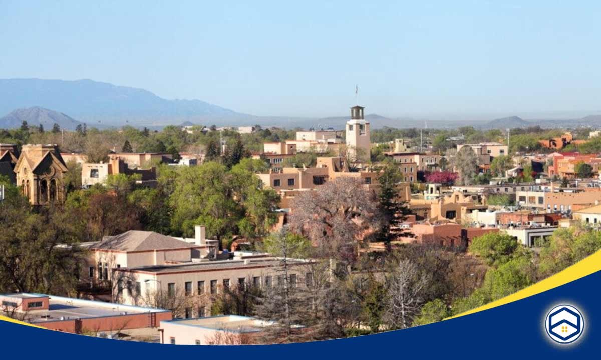 A panoramic view of Eldorado at Santa Fe, showcasing its distinctive adobe architecture and lush greenery