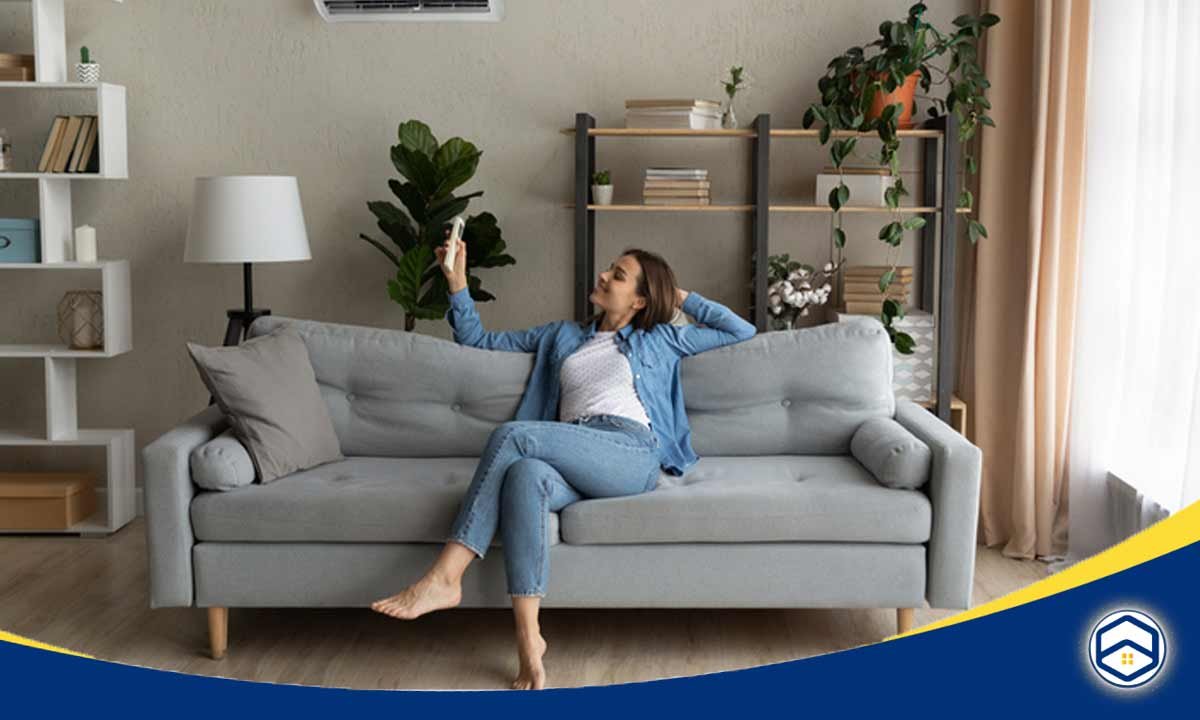 The image shows a woman relaxing comfortably on a sofa in her apartment, highlighting the flexibility and mobility that comes with living in an apartment