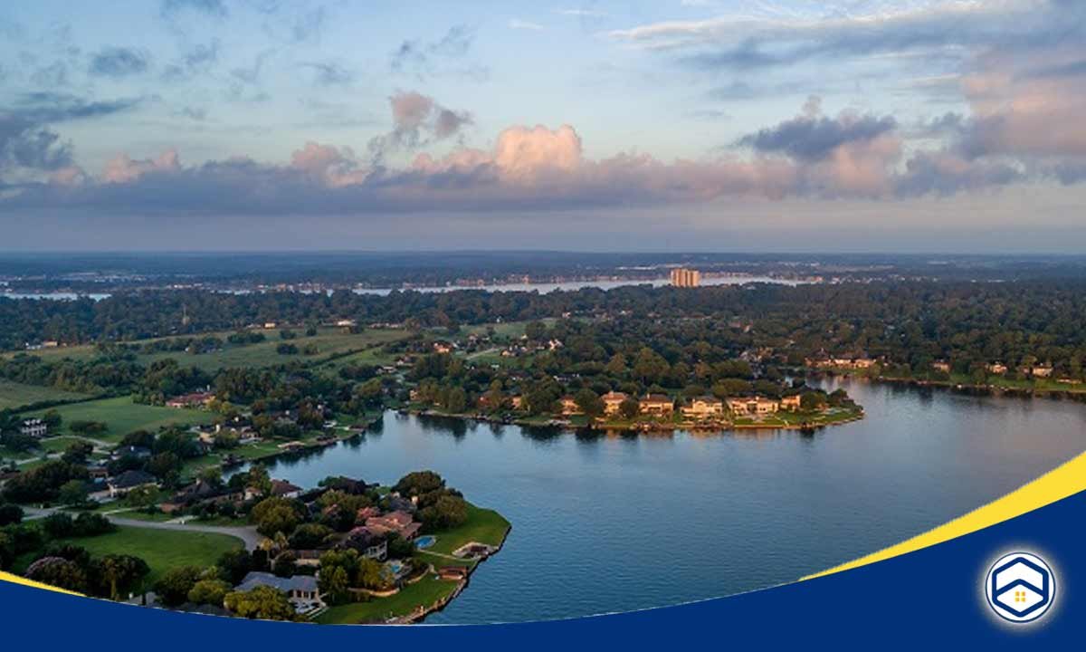 The image shows an aerial view of the Lake Conroe area, highlighting the scenic lakefront properties and surrounding natural landscape.