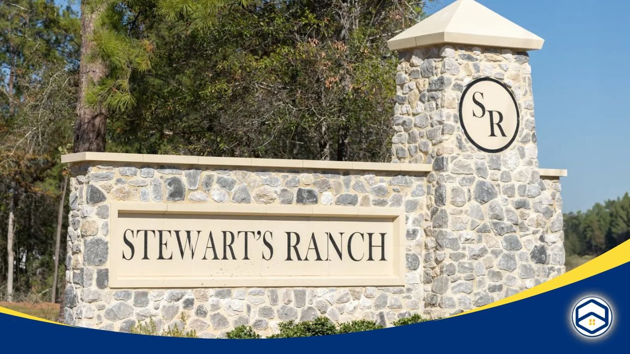 A stone entry sign for Stewart’s Forest surrounded by trees and greenery, welcoming residents to the community.