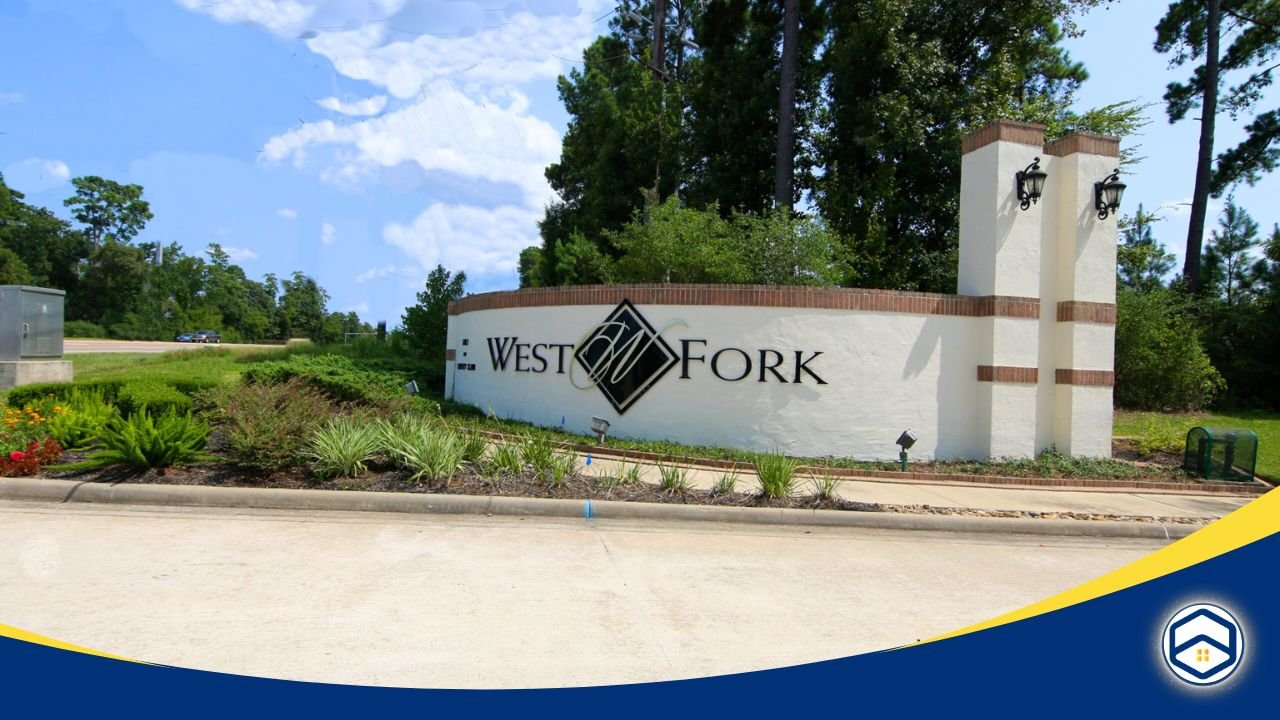 The entrance to West Fork neighborhood featuring a landscaped sign surrounded by greenery and trees.