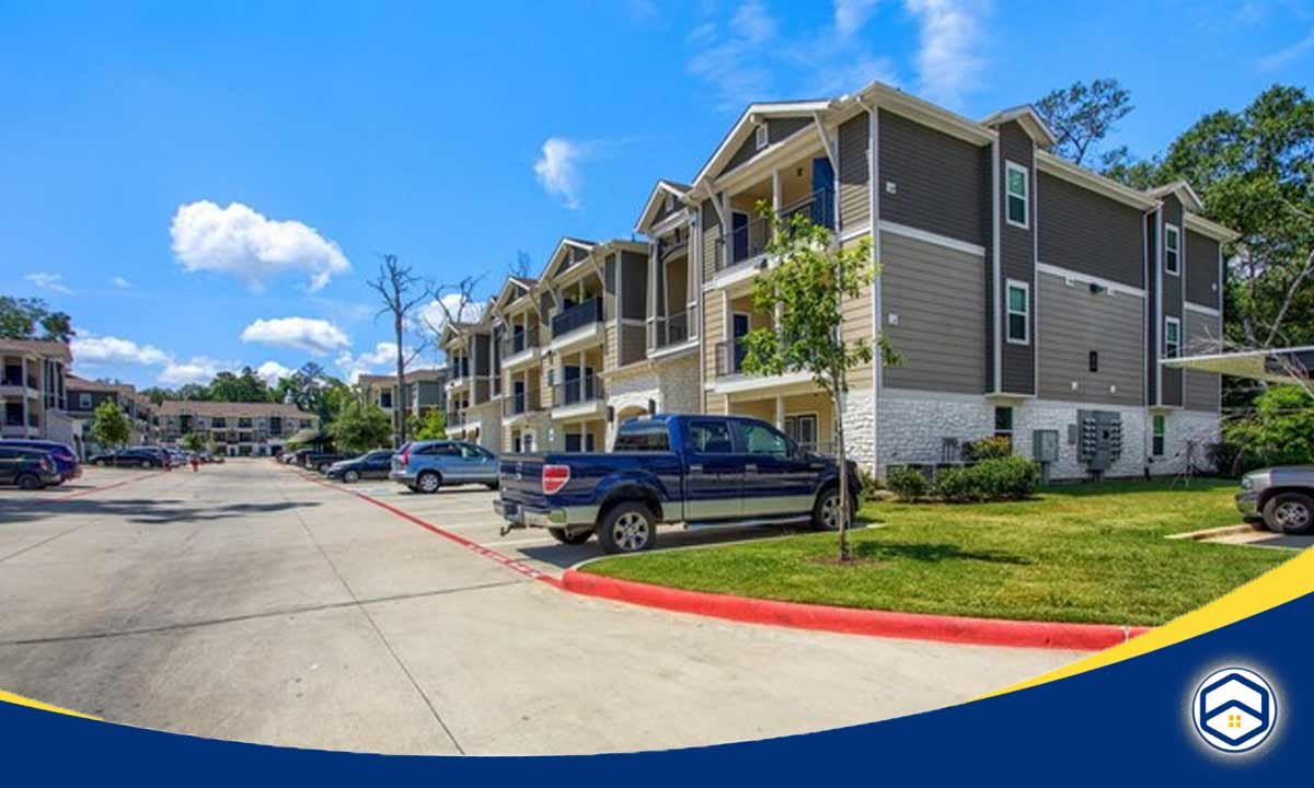 The image shows a modern apartment complex called Urban Oaks at Conroe, which is relevant to the topic of affordable monthly rent in Santa Fe and the benefits of budget apartments.