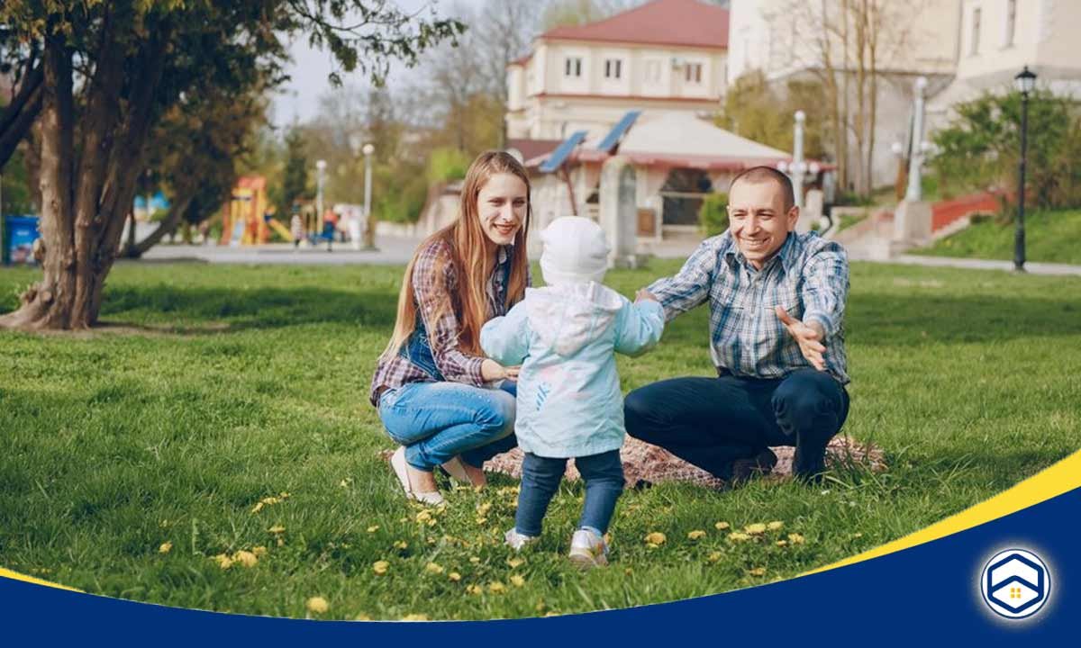 The image appears to show a family - a man, woman, and young child - enjoying a day outdoors in a park or neighborhood setting.