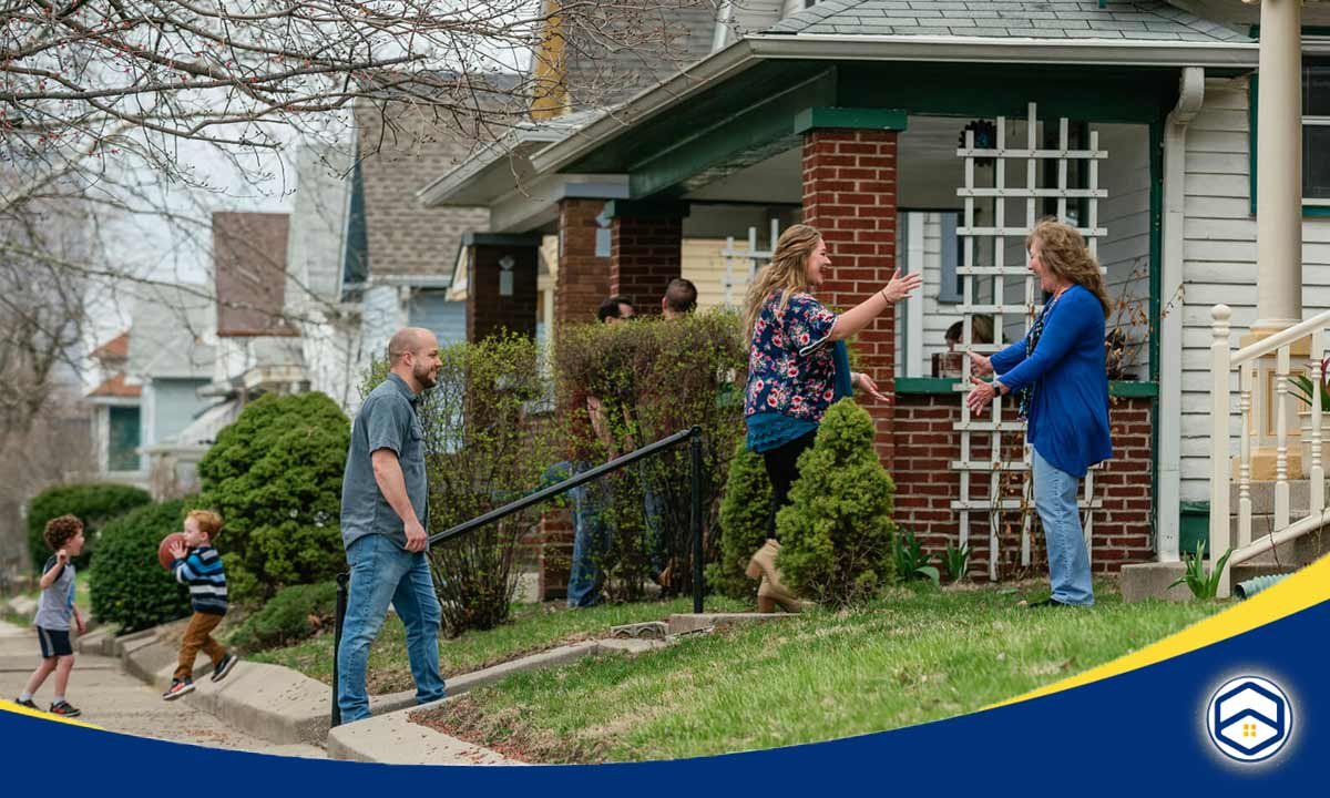 The image shows a group of people interacting and connecting with each other in a neighborhood setting