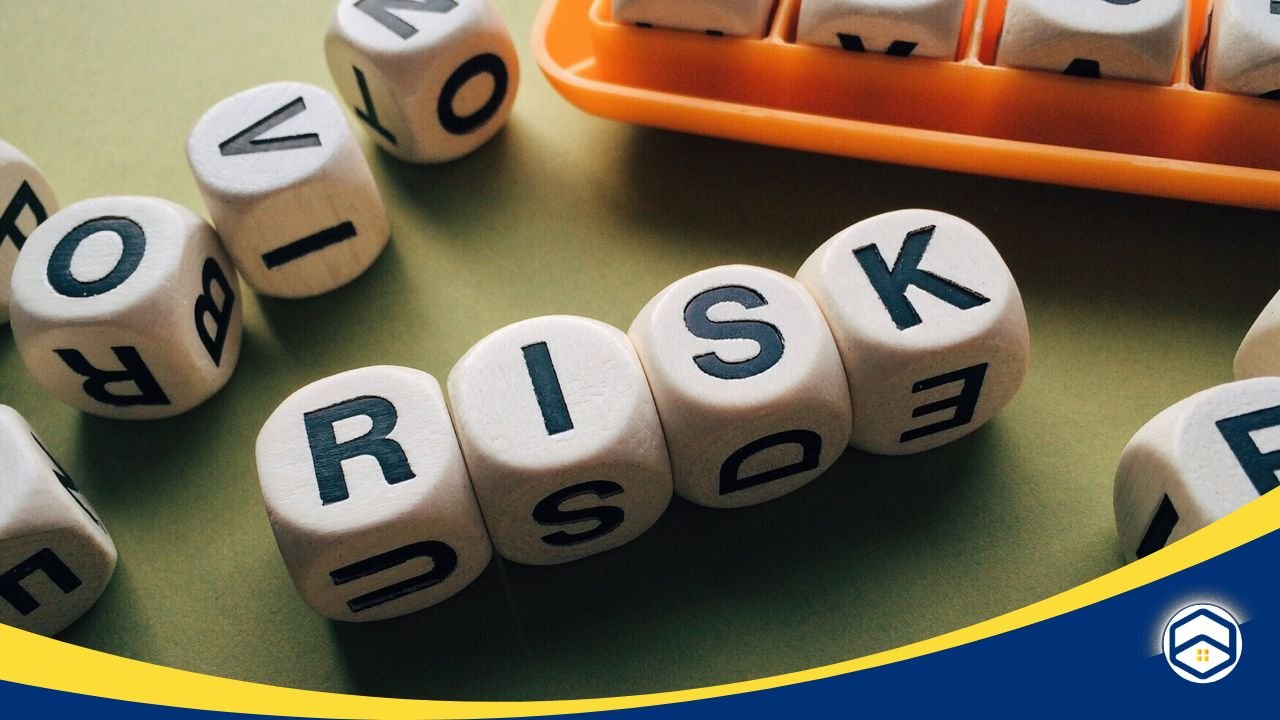 Wooden blocks spelling 'RISK,' representing the importance of understanding local threats like flooding and storms when choosing insurance.