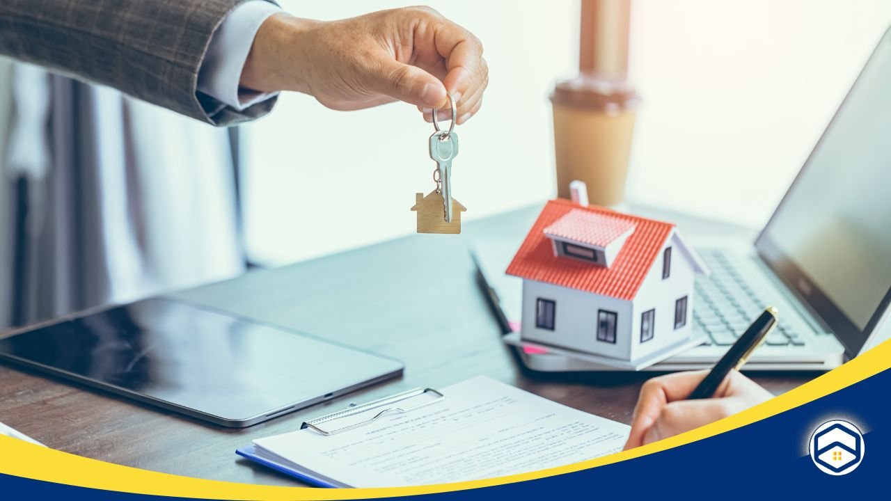 Hand holding house keys over a desk with a lease agreement, a pen, and a miniature house model, symbolizing the lease renewal process.