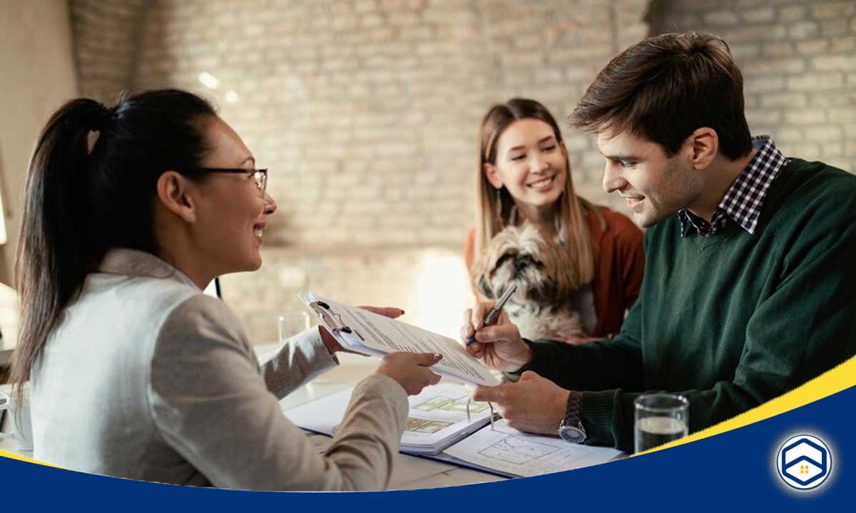 The image appears to show a group of people, likely a real estate agent or insurance agent discussing rental insurance options with a couple.