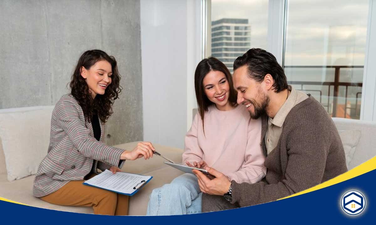 The image shows a couple sitting together on a couch, looking at a document or tablet in their hands. 