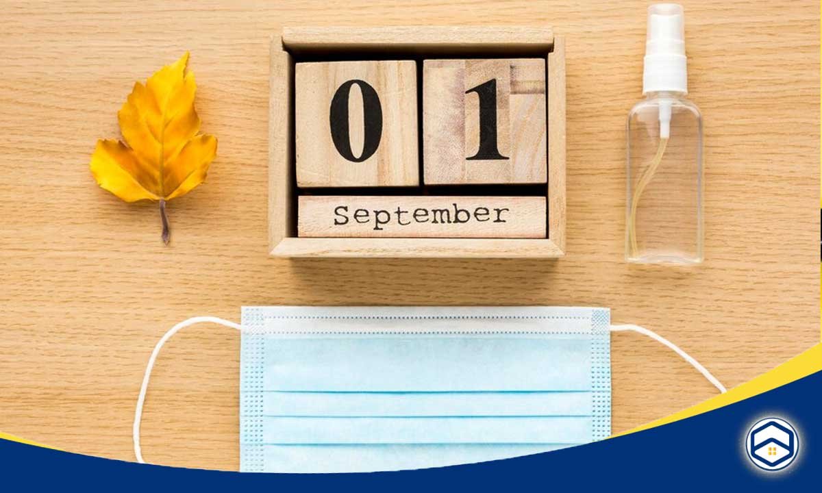 The image features a decorative display of a wooden calendar showing "01 September," accompanied by a leaf, a spray bottle, and a face mask, symbolizing the start of a new month, relevant to monthly Conroe cleaning schedules