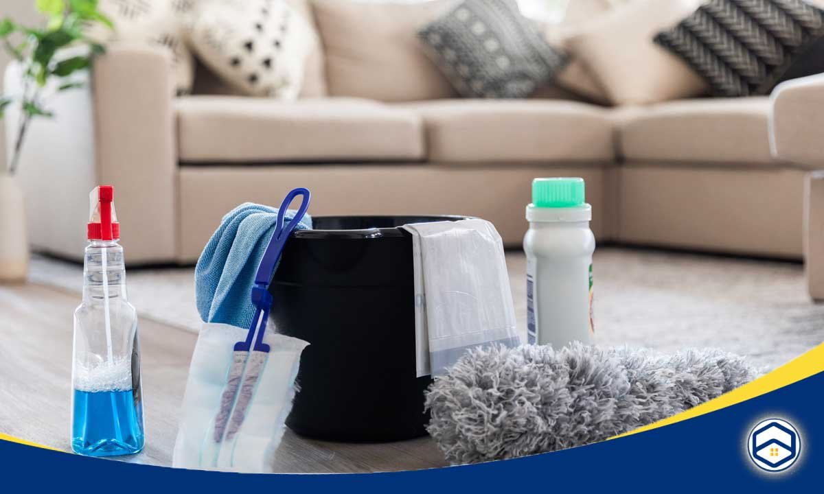 The image shows various cleaning supplies and tools, such as a spray bottle, a microfiber cloth, and a vacuum cleaner, which are relevant to a blog post about deep cleaning schedules in Conroe.