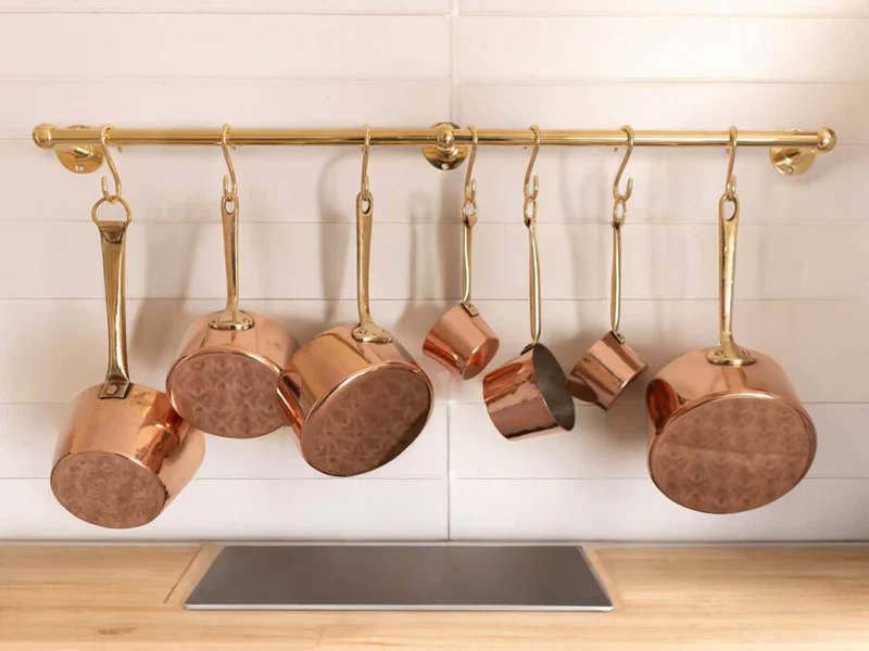 A modern kitchen setup featuring wooden floating shelves filled with spice jars, kitchen utensils, dishware, and a microwave below.